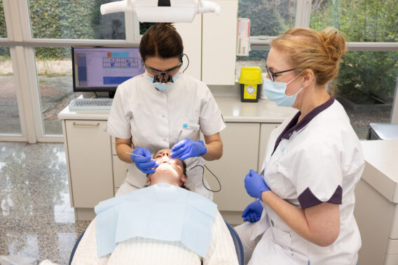Dentist checks teeth patient - Dental Clinics Oudenbosch