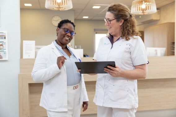 Photo of two colleagues discussing something together at Dental Clinics
