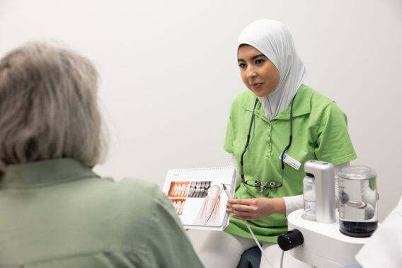 Mondhygiënist legt behandeling uit aan patiënt