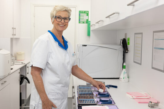 Sterilization Assistant prepares clean instruments at Dental Clinics